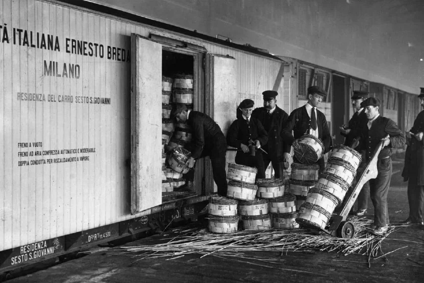 1924 - Workers unload Italian cheese from a rail container in London.