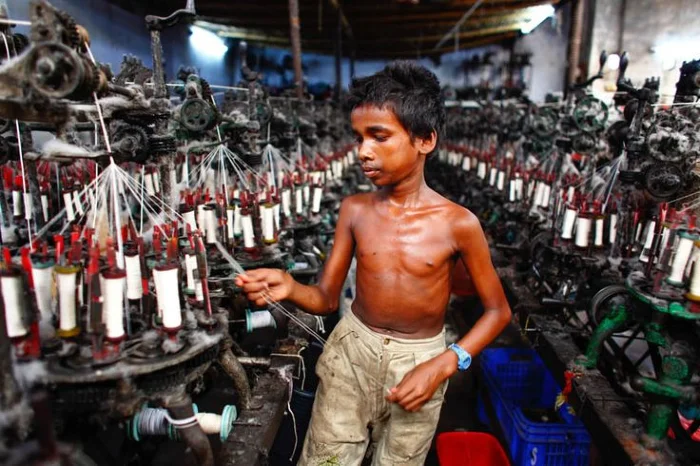 A young boy working in a fast fashion sweatshop in Bangladesh.