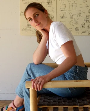 A color photo of industrial designer Mary Lempres casually sitting in a chair.