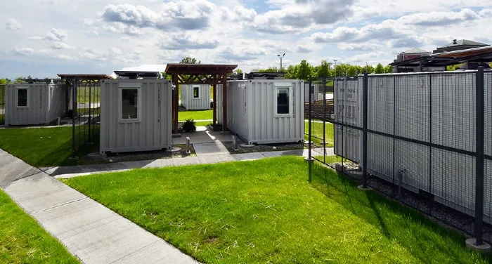 Photo of temporary white shipping containers used as houses.