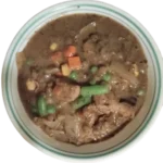 Photo of bowl of soup made from leftover bison meat and frozen vegetables on transparent background.